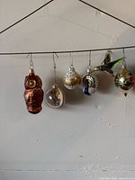 All six ornaments hanging on wire