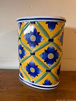 Front view of porcelain umbrella stand showing full pattern