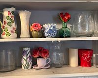 Front view of two shelves showing all glass and ceramic pieces together