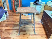 Full view of antique wooden parlour table showing top, legs and claw feet