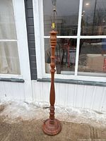 Full view of the turned wood floor lamp with harp and socket