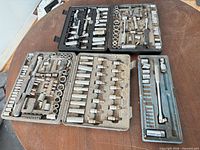 Four open socket cases on table