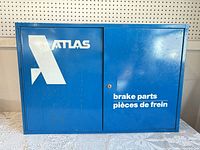 Front view of blue Atlas cabinet showing logo and text