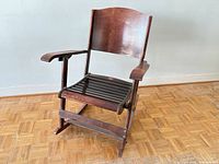 Front view of wooden folding rocking chair showing seat and arms