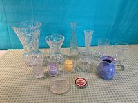 Group shot showing all crystal vases, goblets, bowl, ceramic pitcher, cut glass dish, porcelain dish, and two candles