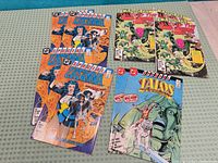 All eight comic books laid out showing covers and quantity duplicates