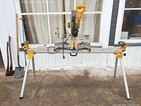 Full view of DeWalt miter saw mounted on folding stand
