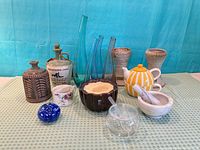 Full grouping front view showing glass vases, paperweight, ceramic pieces, stoneware bottles