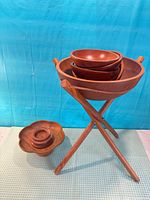 Overall view of stand, large bowl with nested smaller bowls, separate platter with nesting bowls