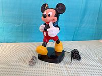 Front view of Mickey Mouse telephone showing figure, base and cords