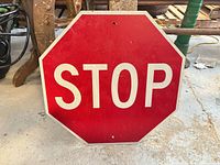 Front of octagonal red STOP sign with white lettering and border