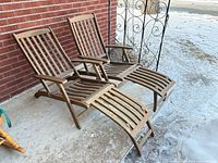 Both teak lounge chairs unfolded on patio