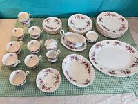 Full assortment of plates, cups, saucers and serving pieces laid out