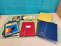 Group shot of five stamp albums and smaller booklets