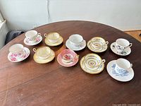 All ten teacup and saucer sets on tabletop
