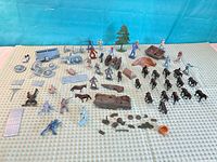 Full layout of all figures, vehicles, animals and accessories on patterned cloth