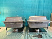 Front view of both chafing dish sets assembled with stands and fuel holders