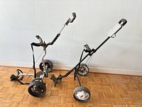 Both collapsible golf pull carts side by side showing overall condition