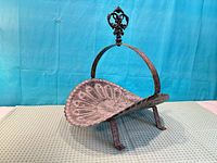 Front view showing entire log cradle with finial and legs