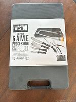 Front view of unopened Weston 10-piece game processing knife set carry case