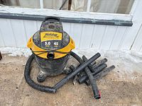 Front view of Workshop wet/dry vac showing brand logo, hose and attachments