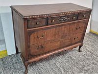 Front view of chest showing drawers, hardware, legs