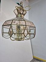 Full view of brass-tone and slag glass ceiling light