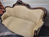 Front view of carved mahogany settee