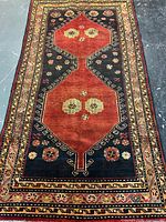 Full view of handmade Persian rug showing design and borders