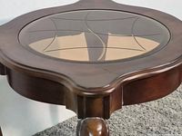 Top view showing round glass inset with geometric pattern and wood frame