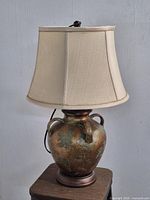 Full view of lamp showing urn base, handles and shade