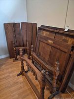 Disassembled table parts including leaves and legs