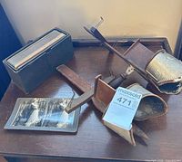 Two wood and metal stereoscopes, stereoview cards in black box, loose cards visible