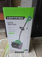 Front of box showing Certified electric snow shovel packaging