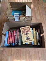 Two boxes filled with assorted faith and spirituality books, including a matched set of paperbacks and various hardcovers/paperbacks