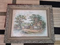 Rural landscape artwork in ornate frame