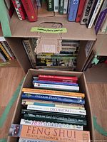 Two boxes of assorted books, top view shows titles and quantity