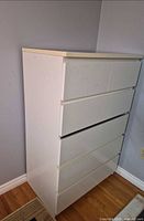 Full view of white six-drawer dresser showing overall design and size