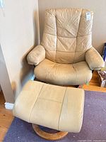 Front view of chair and ottoman showing style and color