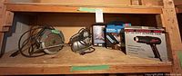 Lot overview on shelf showing circular saw, jigsaw, two boxed glue guns and boxed heat gun
