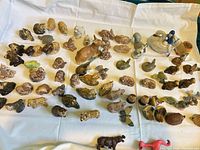 Full assortment of Wade figurines spread on white cloth