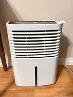 Front view of Whirlpool dehumidifier showing grille and water level window