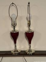 Front view of both matching burgundy chrome table lamps with bulbs