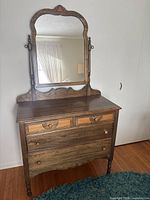 Front view of elm dresser with attached mirror showing four drawers and turned legs