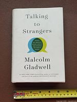 Front cover showing title, author, and graphics with measuring tape for scale