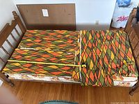 Four folded curtain panels on bed with measuring tape showing length and width