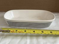 Top angled view showing interior, stripe pattern and tape measure indicating length