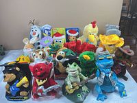 Group shot of all animated plush characters displayed on table