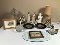 Overall lot showing lamps, figurines, plates, artworks and glass pieces