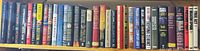 Full shelf showing approximately 35 assorted mystery & crime books